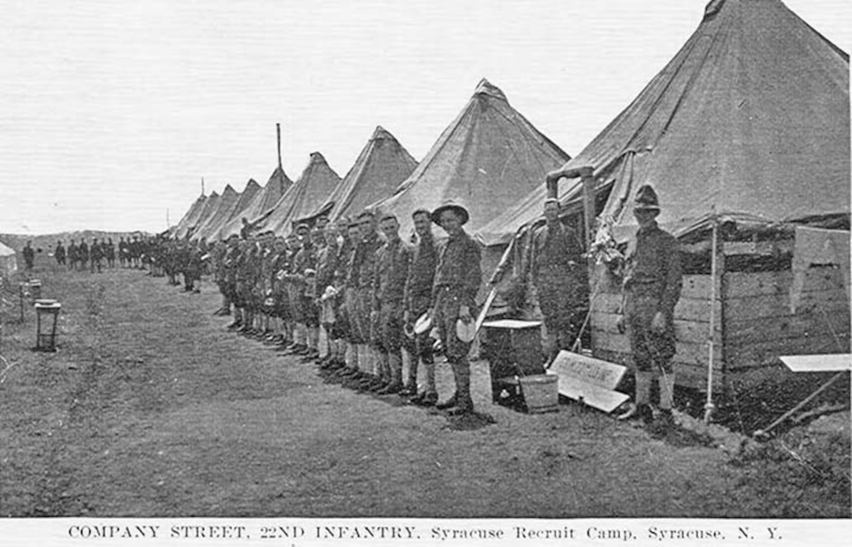 U.S. Army Soldiers stand on a typical company street at Camp Syracuse, N.Y., in 1918. The camp provided training to new recruits and National Guard Citizen-Soldiers in America’s mobilization for World War I. Camp Syracuse, located on a portion of the New York state fairgrounds, processed more than 40,000 Soldiers for the war effort.