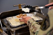 A U.S. Army Soldier spoons rice onto a plate during the Asian American and Pacific Islander heritage event at the Event Center on Goodfellow Air Force Base, Texas, May 18, 2018. Included in the event were booths that displayed Items important to each country such as ceremonial clothes, traditional art and religious artifacts. (U.S. Air Force photo by Senior Airman Randall Moose/Released)