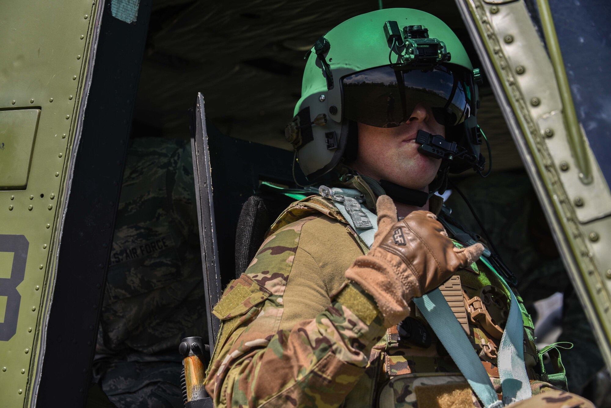 Captain Isaac Fifield, 582nd Operation Support Squadron pilot, poses for a photo after landing the helicopter during 90th Mission Support Group Warrior Day, May 19, 2018, on F.E. Warren Air Force Base, Wyo. Several helicopters landed on the parade field during the event, giving Airmen the opportunity to take part in an incentive flight after the day’s training. The Warrior Day was an all-day training event to reinforce deployment preparedness, warrior ethos and a commitment to teamwork. (U.S. Air Force photo by Airman 1st Class Abbigayle Wagner)