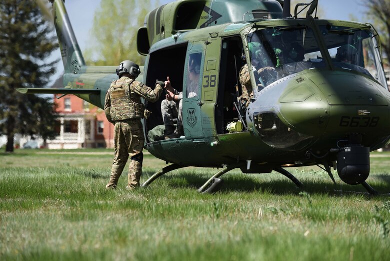 Staff Sgt. Travis Akerson, 37th Helicopter Squadron flight engineer, checks with each Airman on the incentive flight to verify they are good-to-go and strapped in, May 19, 2018, on F.E. Warren Air Force Base, Wyo. The flight was a pre-planned scenario that required Airmen to preform self-aid buddy care and call medical evacuation, followed by “injured Airmen” boarding the helicopter. The Warrior Day was an all-day training event to reinforce deployment preparedness, warrior ethos and a commitment to teamwork. (U.S. Air Force photo by Airman 1st Class Abbigayle Wagner)