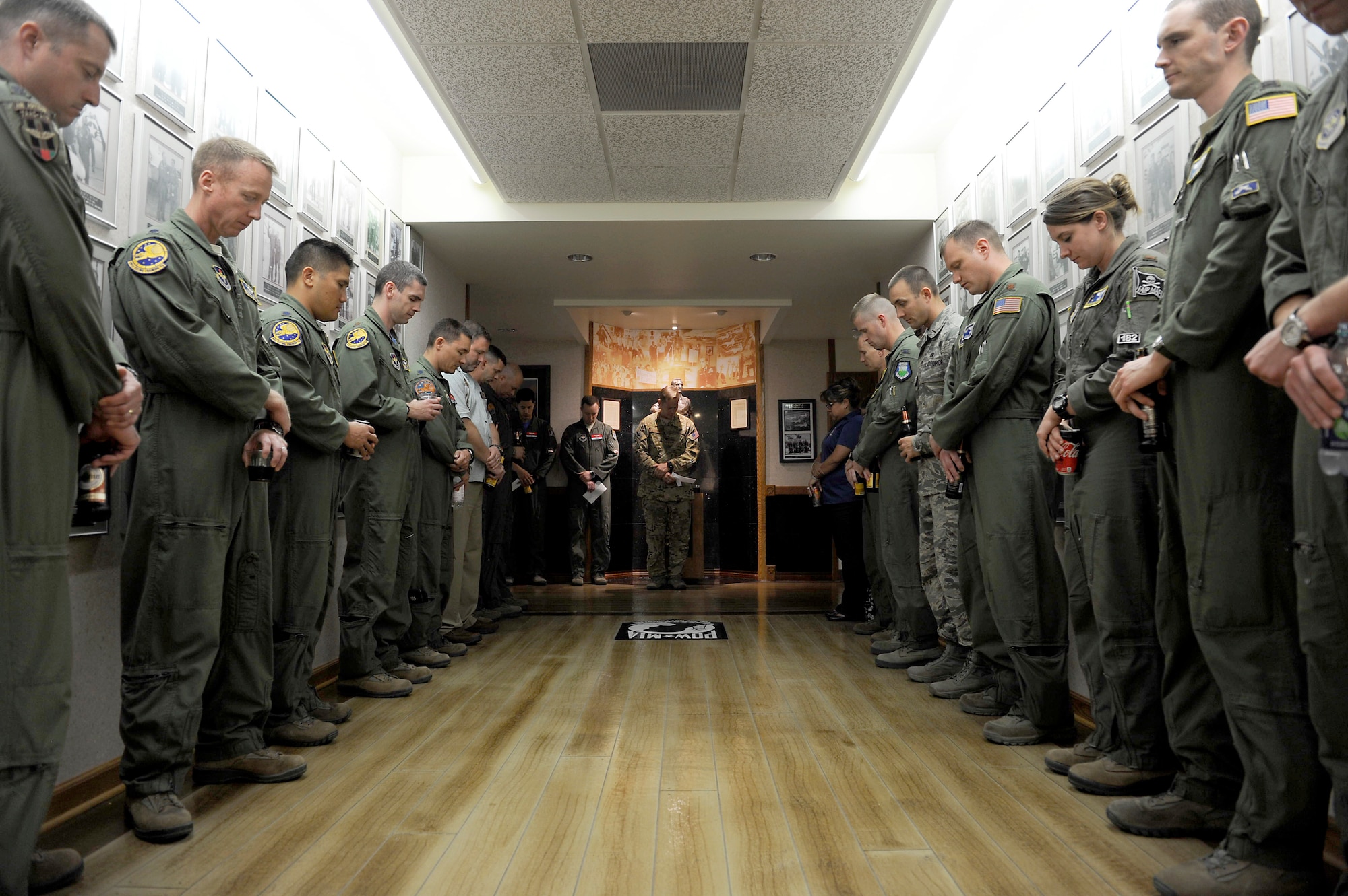 Members of the 99th Flying Training Squadron line Freedom Flyer hallway of Hangar 12 during a roll call for the NATO Air Training Command Afghanistan, NATC-A NINE, April 27, 2018, Randolph AFB, Texas. On this day in 2011 a shooter opened fire at the Kabul International Airport, killing eight Airmen and one American contractor. Among the victims was Maj. Jeff ‘Oz’ Ausborn, who was deployed from the 99th FTS. (U.S. Air Force photo by Tech. Sgt. Ave I. Young)