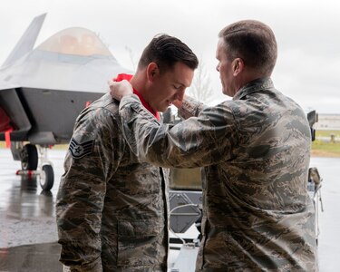 U.S. Air Force Col. Mathew Powell, commander of the 3rd Maintenance Group, places a winner’s medal on Staff Sgt. Randall Stoiner after the Wing Weapons Load Crew 1st Quarter Competition May 18, 2018, at Joint Base Elmendorf-Richardson, Alaska. A weapons load crew is a group of three people responsible for preparing and loading munitions onto an aircraft. Stoiner was the team chief for the 90th Aircraft Maintenance Unit Weapons Section.