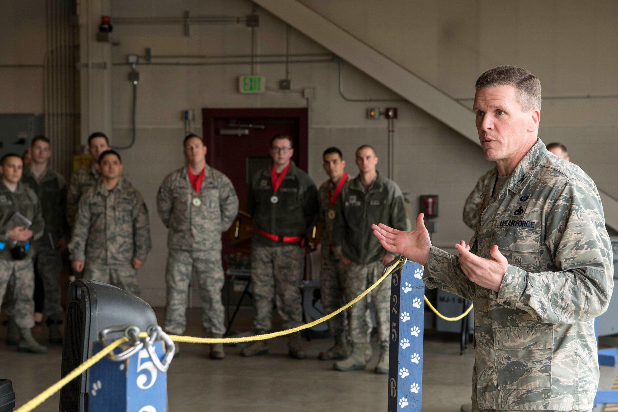 U.S. Air Force Col. Mathew Powell, commander of the 3rd Maintenance Group, speaks to attendees of the Quarterly Wing Weapons Load Crew Competition May 18, 2018, at Joint Base Elmendorf-Richardson, Alaska. Powell was congratulating the weapons load crew from the 90th Aircraft Maintenance Unit Weapons Section for winning the competition, and encouraging units to use this as a reminder to be vigilant.
