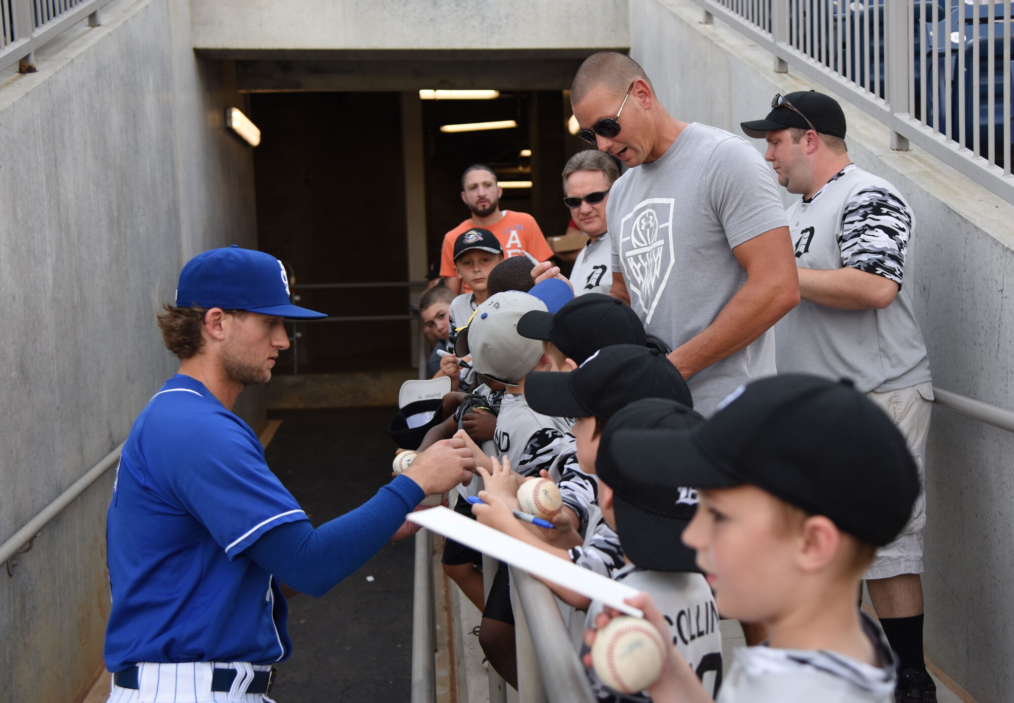 Jake Hager, Biloxi Shuckers short stop, signs autographs for Officer Justin Depew, 81st Security Forces Squadron unit trainer, and his team during a Biloxi Shuckers baseball game, in Biloxi, Mississippi, May 17, 2018. Keesler leadership also participated in pre-game festivities. (U.S. Air Force photo by Kemberly Groue)