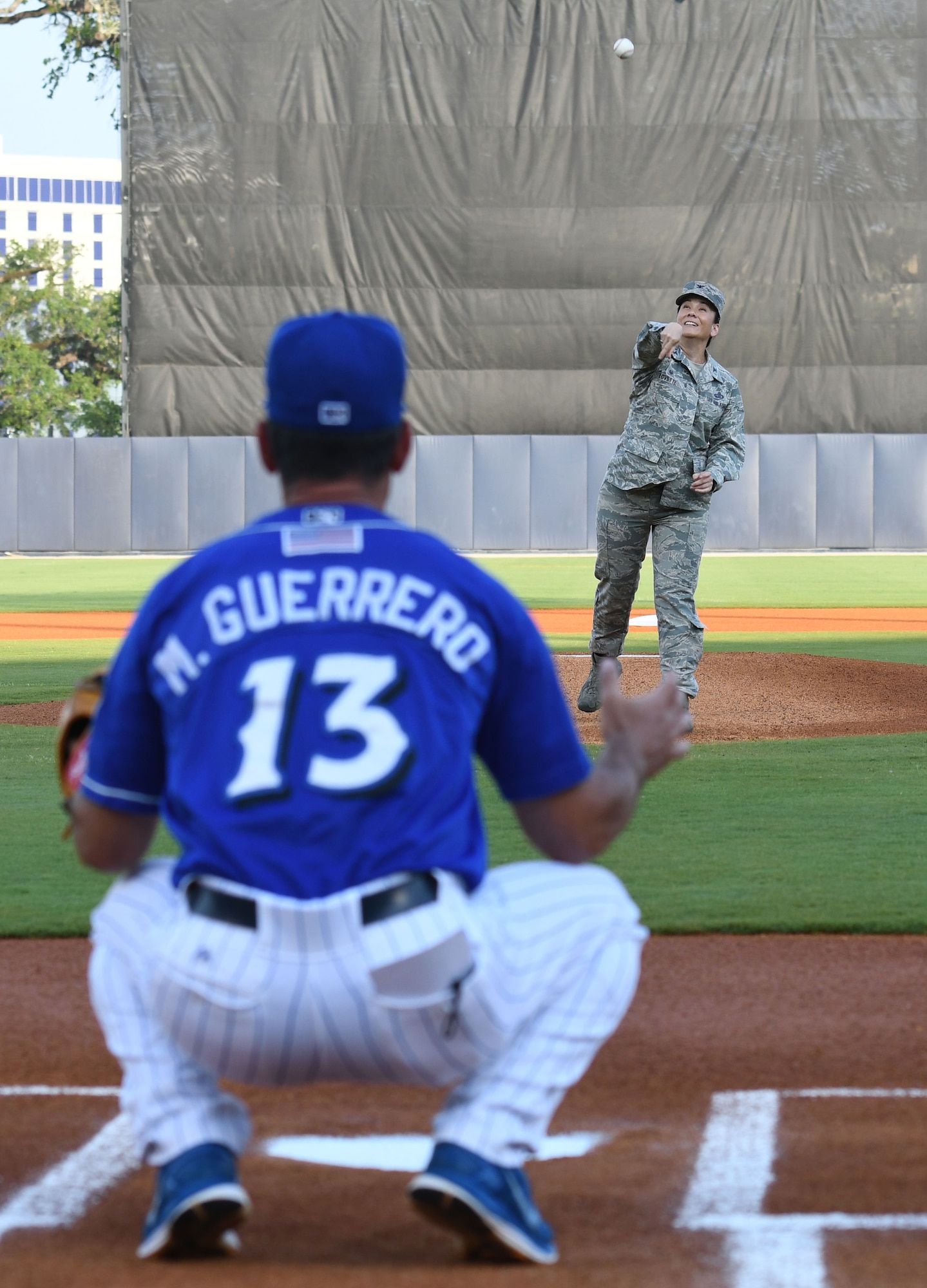 Col. Debra A. Lovette, 81st Training Wing commander, throws the first pitch to Mike Guerrero, Biloxi Shuckers manager, during a Biloxi Shuckers baseball game, in Biloxi, Mississippi, May 17, 2018. Lovette also participated in other pre-game festivities. (U.S. Air Force photo by Kemberly Groue)