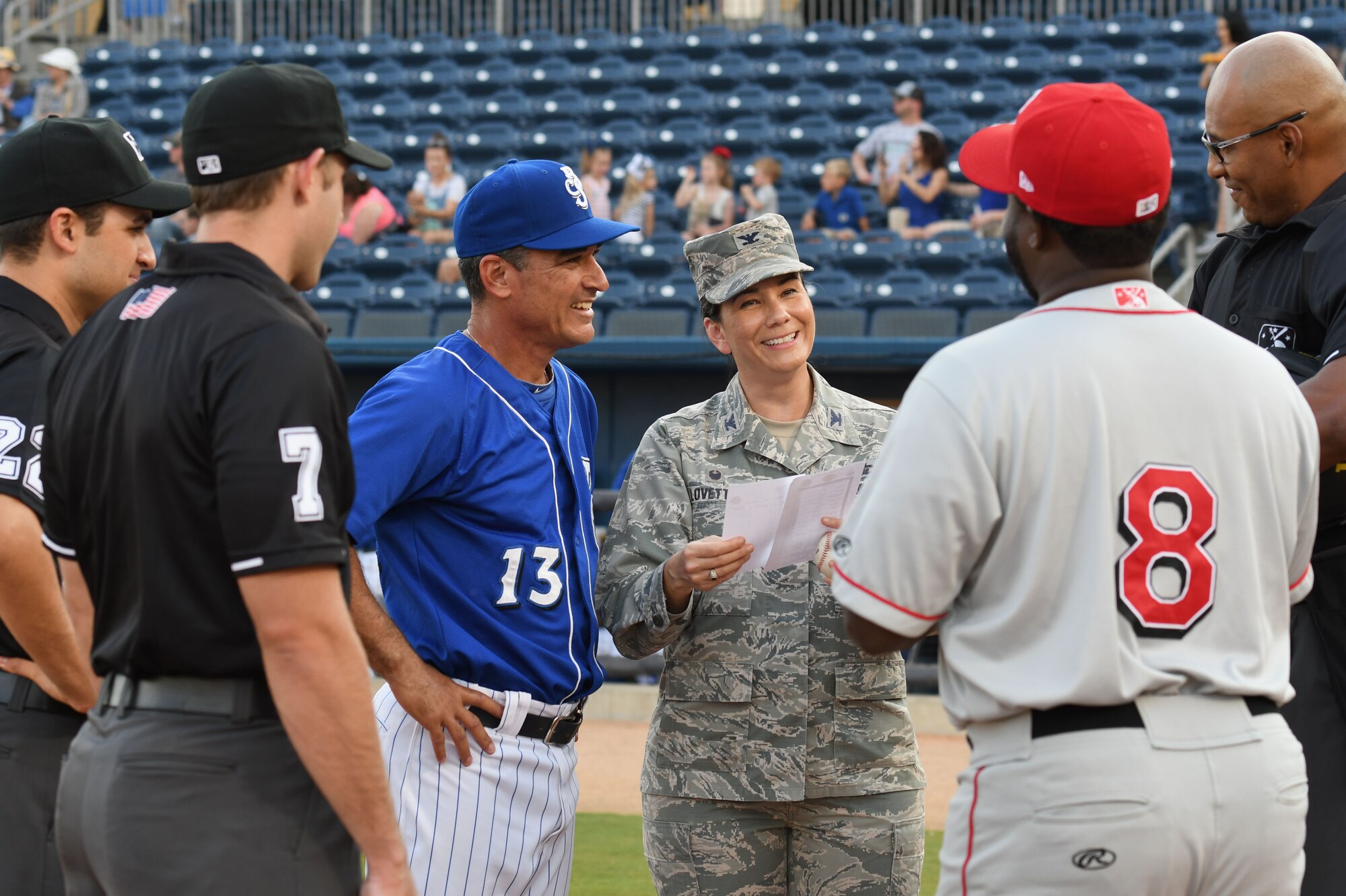 Col. Debra A. Lovette, 81st Training Wing commander, joins Mike Guerrero, Biloxi Shuckers manager, at home plate to meet with the umpires and the opposing team’s manager during a Biloxi Shuckers baseball game, in Biloxi, Mississippi, May 17, 2018. Lovette also threw the first pitch during pre-game festivities. (U.S. Air Force photo by Kemberly Groue)