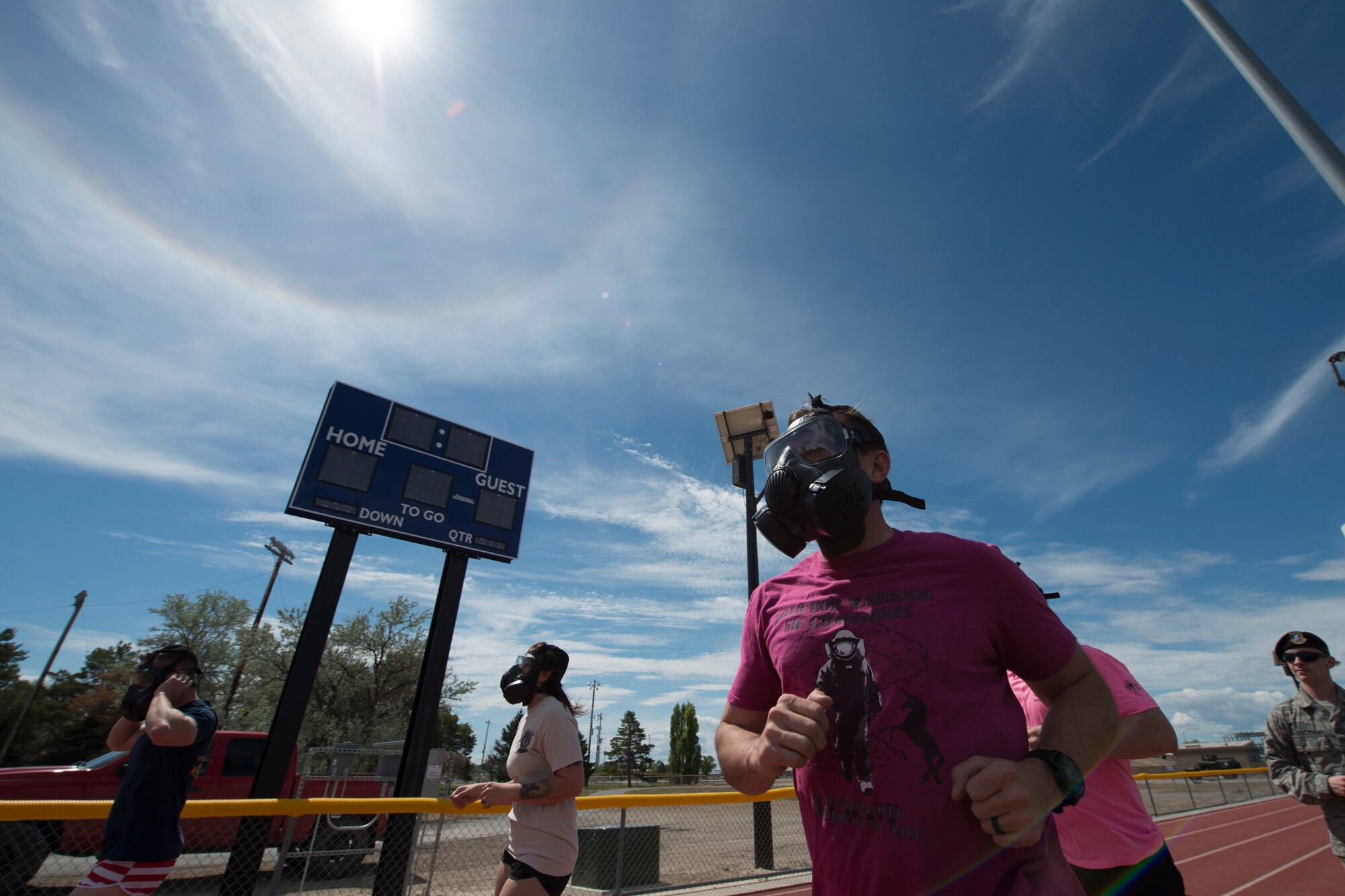 Competitors run for a quarter mile in gas masks during the Defender Led Challenge, May 16, 2018, at Mountain Home Air Force Base, Idaho. The Defender Led challenge is a National Police Week event held for local base agencies to compete against each other in numerous physical activities. (U.S. Air Force Photo by Airman 1st Class JaNae Capuno)