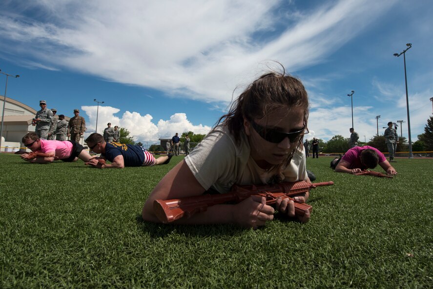 Competitors participate in a low crawl race during the Defender Led Challenge, May 16, 2018, at Mountain Home Air Force Base, Idaho. The Defender Led challenge is a National Police Week event held for local base agencies to compete against each other in numerous physical activities. (U.S. Air Force Photo by Airman 1st Class JaNae Capuno)