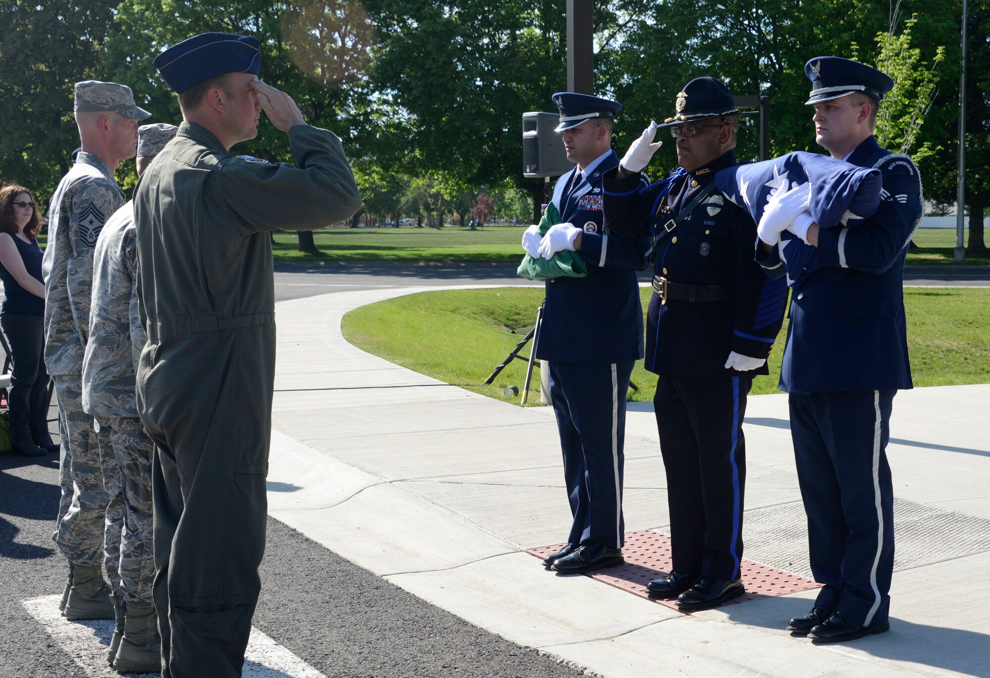 Col. Johan Deutscher, 141st Air Refueling Wing commander, renders a salute to the colors presented by members of the Fairchild Air Force Base Honor Guard and a law enforcement officer during a National Police Week Memorial Retreat Ceremony at Fairchild AFB, Washington, May 16, 2018. A retreat ceremony was held in remembrance of fallen law enforcement members with the U.S. flag being retired.