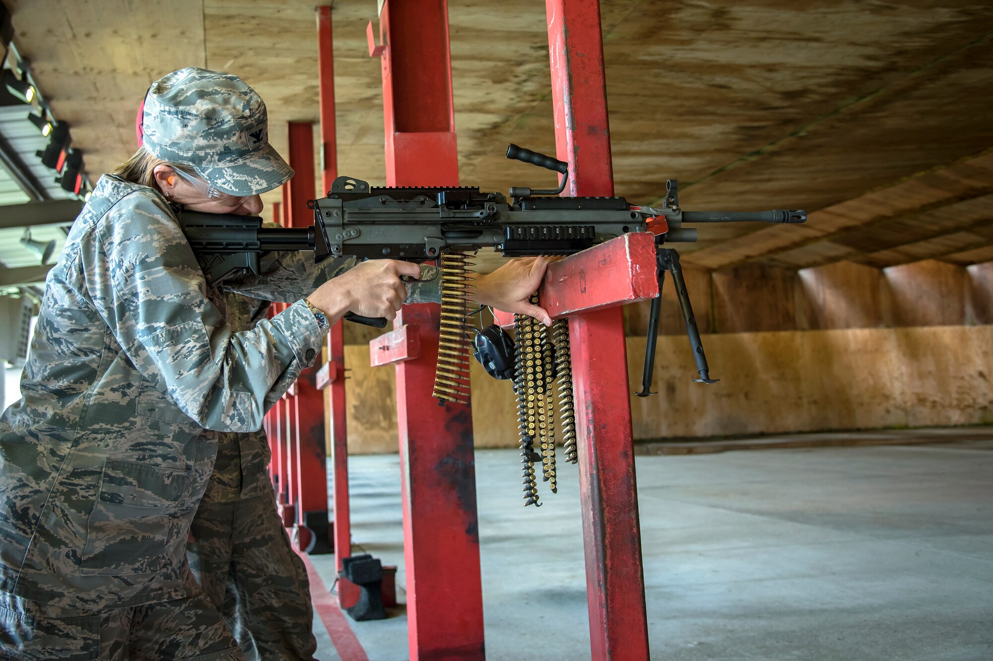 Col. Jennifer Short, left, 23d Wing commander, fires an M240B machine gun during an immersion tour, May 21, 2018, at Moody Air Force Base, Ga. Short toured the 23d Mission Support Group (MSG) to gain a better understanding of their overall mission, capabilities, and comprehensive duties. Short was able to meet and interact with Airmen from the combat arms training and maintenance as well as the chemical, biological, radiological and nuclear defense sections of the MSG. (U.S. Air Force photo by Airman 1st Class Eugene Oliver)