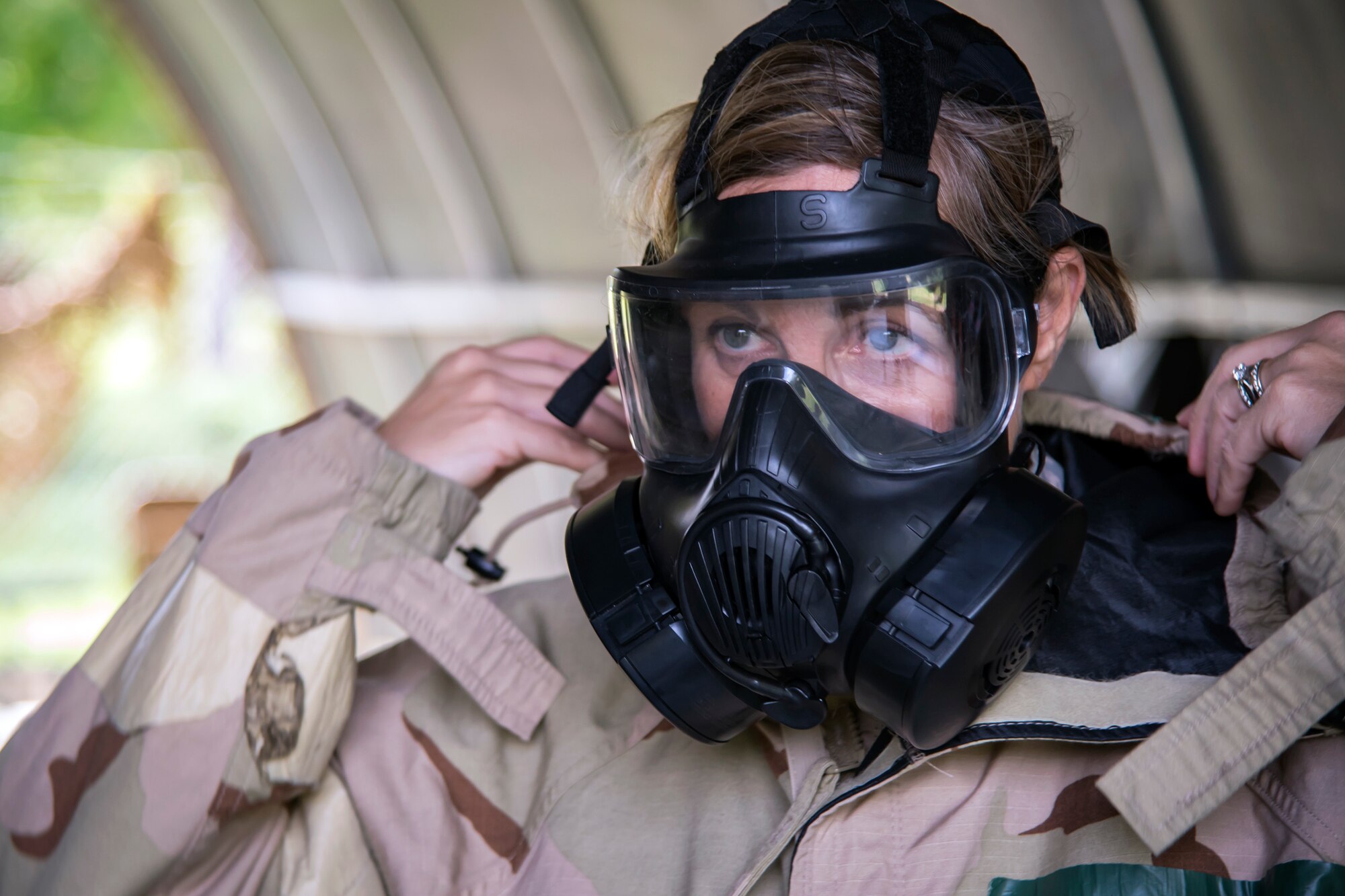 Col. Jennifer Short, 23d Wing commander, dons Mission Oriented Protective Posture gear during an immersion tour, May 21, 2018, at Moody Air Force Base, Ga. Short toured the 23d Mission Support Group (MSG) to gain a better understanding of their overall mission, capabilities, and comprehensive duties. Short was able to meet and interact with Airmen from the combat arms training and maintenance as well as the chemical, biological, radiological and nuclear defense sections of the MSG. (U.S. Air Force photo by Airman 1st Class Eugene Oliver)