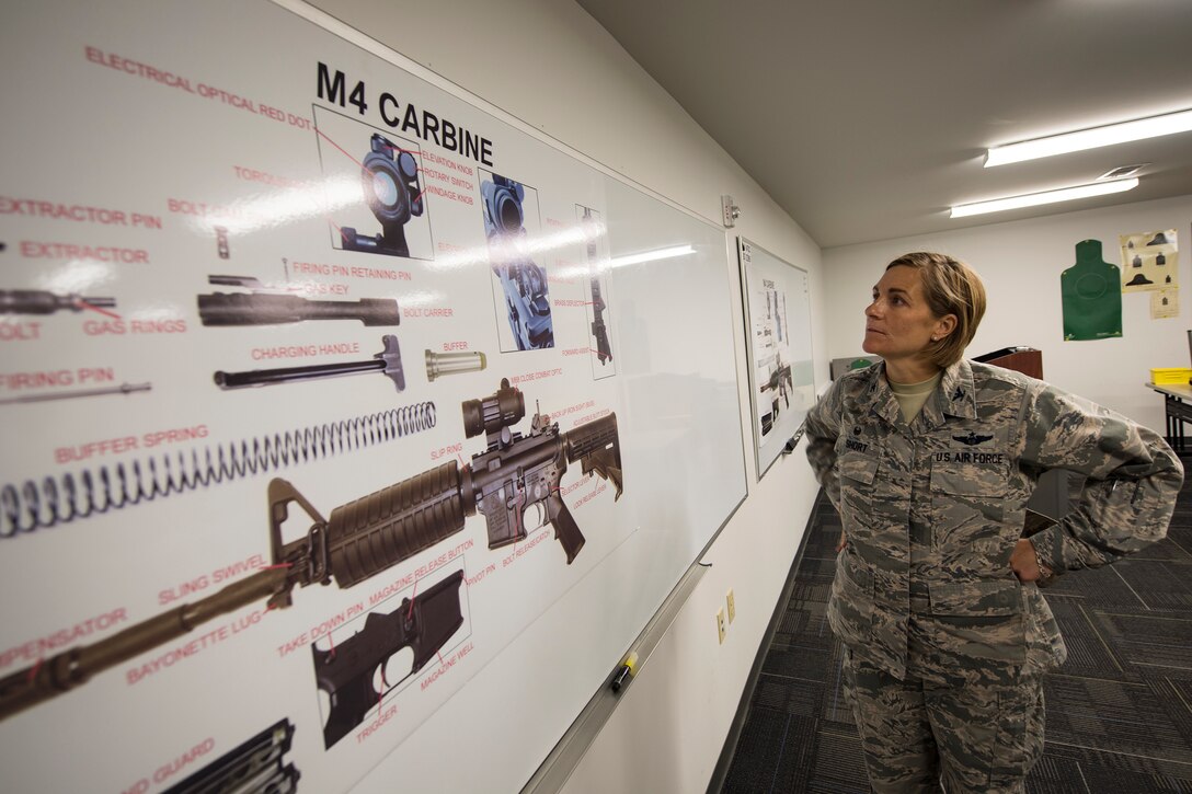 Col. Jennifer Short, 23d Wing commander, studies M4 Carbine components during an immersion tour, May 21, 2018, at Moody Air Force Base, Ga.  Short toured the 23d Mission Support Group (MSG) to gain a better understanding of their overall mission, capabilities, and comprehensive duties. Short was able to meet and interact with Airmen from the combat arms training and maintenance as well as the chemical, biological, radiological and nuclear defense sections of the MSG. (U.S. Air Force photo by Airman 1st Class Eugene Oliver)