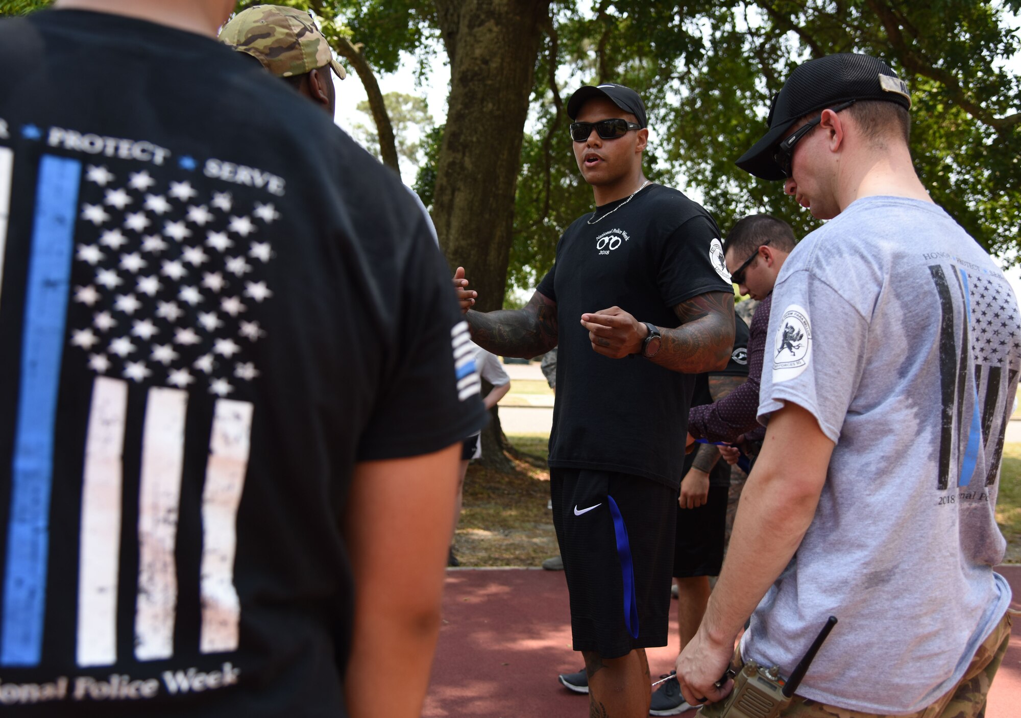 U.S. Air Force Tech. Sgt. Anthony Horton, 81st Security Forces Squadron training NCO in charge, delivers closing remarks during the 81st SFS 5K Fallen Defender Ruck and Obstacle Course competition at the Crotwell Track at Keesler Air Force Base, Mississippi, May 15, 2018. The event was held during National Police Week, which recognizes the service of law enforcement men and women who put their lives at risk every day. (U.S. Air Force photo by Kemberly Groue)