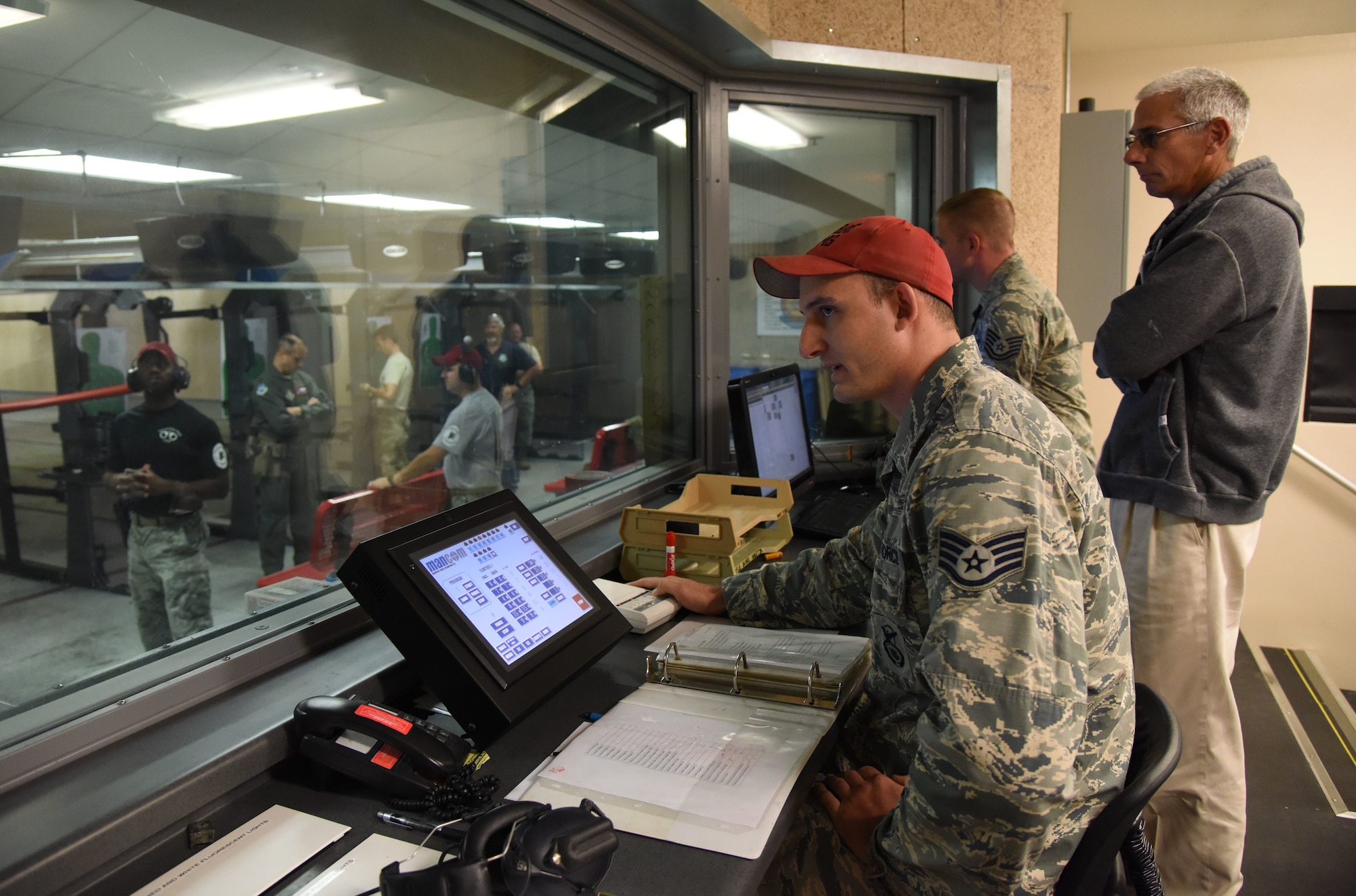 U.S. Air Force Staff Sgt. Joshua Green, 81st Security Forces Squadron combat arms instructor, provides safety instructions to personnel participating in the 81st SFS law enforcement team competition shoot in the indoor firing range at Keesler Air Force Base, Mississippi, May 16, 2018. The event was held during National Police Week, which recognizes the service of law enforcement men and women who put their lives at risk every day. (U.S. Air Force photo by Kemberly Groue)