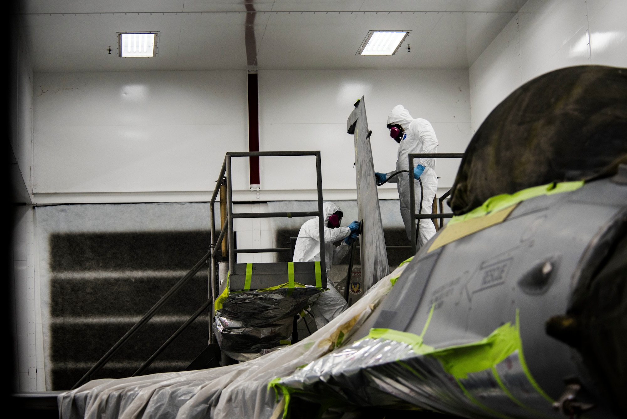 U.S. Airmen assigned to the 20th Equipment Maintenance Squadron corrosion control section sand down an F-16CM Fighting Falcon at Shaw Air Force Base, S.C., May 15, 2018.