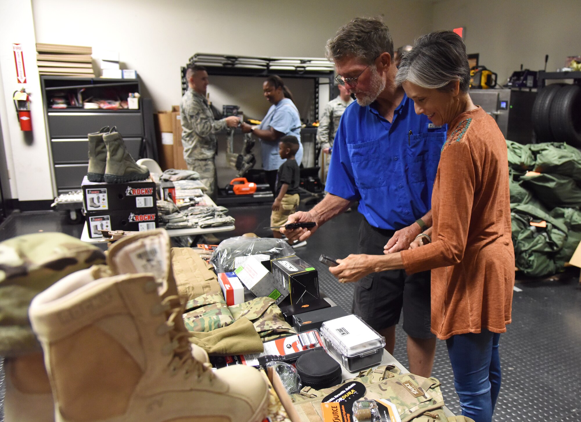 Brad and Cindy Bordes, grandparents of U.S. Air Force Airman Noah Hill, 81st Security Forces Squadron entry controller, inspect uniforms and equipment worn by 81st SFS Airmen during the 81st SFS open house at Keesler Air Force Base, Mississippi, May 17, 2018. The open house allowed individuals to walk through a day in the life of a defender. The event was held during National Police Week, which recognizes the service of law enforcement men and women who put their lives at risk every day. (U.S. Air Force photo by Kemberly Groue)