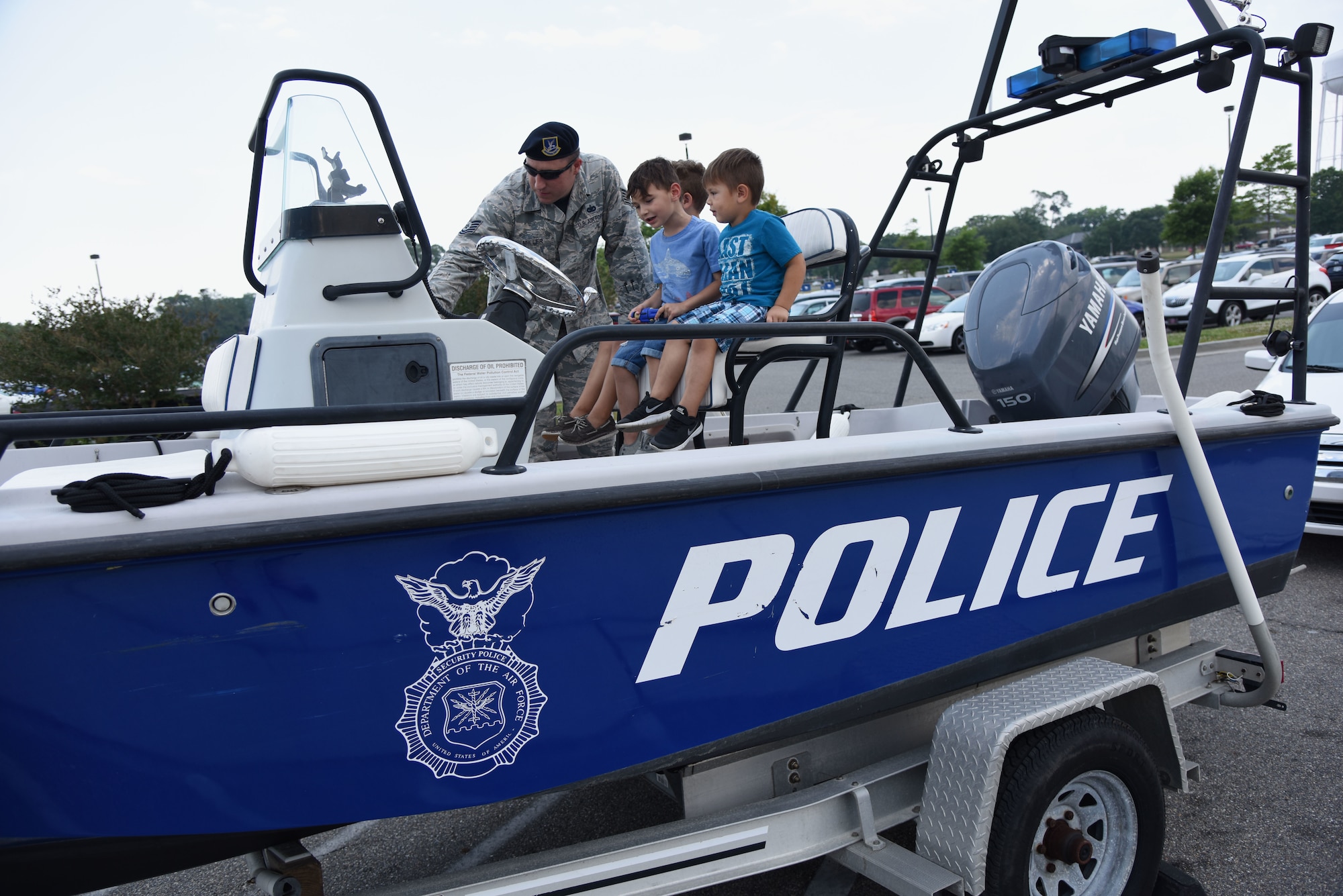 U.S. Air Force Tech. Sgt. Jared Miller, 81st Security Forces Squadron unit deployment manager, gives a tour of the 81st SFS patrol boat to kids during the 81st SFS fun day at the base exchange at Keesler Air Force Base, Mississippi, May 18, 2018. Fun day allowed individuals to view a military working dog demonstration, a combat arms weapons stand as well as tour SFS vehicles and equipment. The event was held during National Police Week, which recognizes the service of law enforcement men and women who put their lives at risk every day. (U.S. Air Force photo by Kemberly Groue)