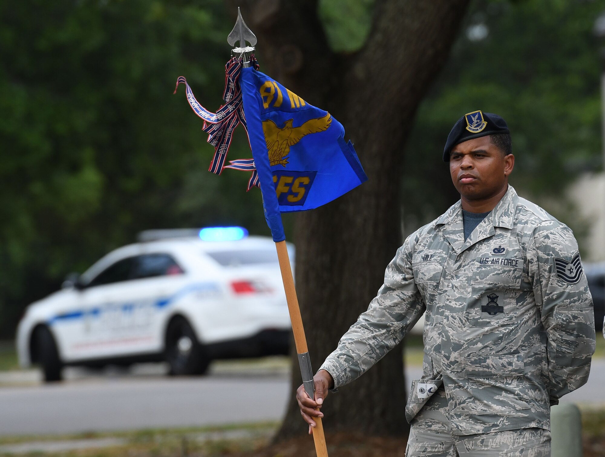 U.S. Air Force Tech. Sgt. Courtney Hill, 81st Security Forces Squadron commander support staff NCO in charge, holds the 81st SFS guidon during the 81st SFS retreat ceremony at Keesler Air Force Base, Mississippi, May 18, 2018. The event was held during National Police Week, which recognizes the service of law enforcement men and women who put their lives at risk every day. (U.S. Air Force photo by Kemberly Groue)
