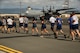 Airmen from 515th Air Mobility Operations Wing run in formation during the 5th Annual Port Dawg Memorial Run at Joint Base Pearl Harbor-Hickam, Hawaii, May 18, 2018. The purpose of the run was to honor and remember fallen Port Dawgs, Airmen who lost their lives in the air transportation career field. (Photo by Tech. Sgt. Heather Redman)