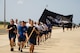 Airmen from 515th Air Mobility Operations Wing run in formation during the 5th Annual Port Dawg Memorial Run at Joint Base Pearl Harbor-Hickam, Hawaii, May 18, 2018. The purpose of the run was to honor and remember fallen Port Dawgs, Airmen who lost their lives in the air transportation career field. (Photo by Tech. Sgt. Heather Redman)