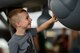 A child gets an up-close view of the MQ-9 Reaper at Joint Base Langley-Eustis, Virginia, May 19, 2018. This was the first time the MQ-9 Reaper was displayed during an air show at the Air Combat Command headquarters. (U.S. Air Force photo by Airman 1st Class Haley Stevens)