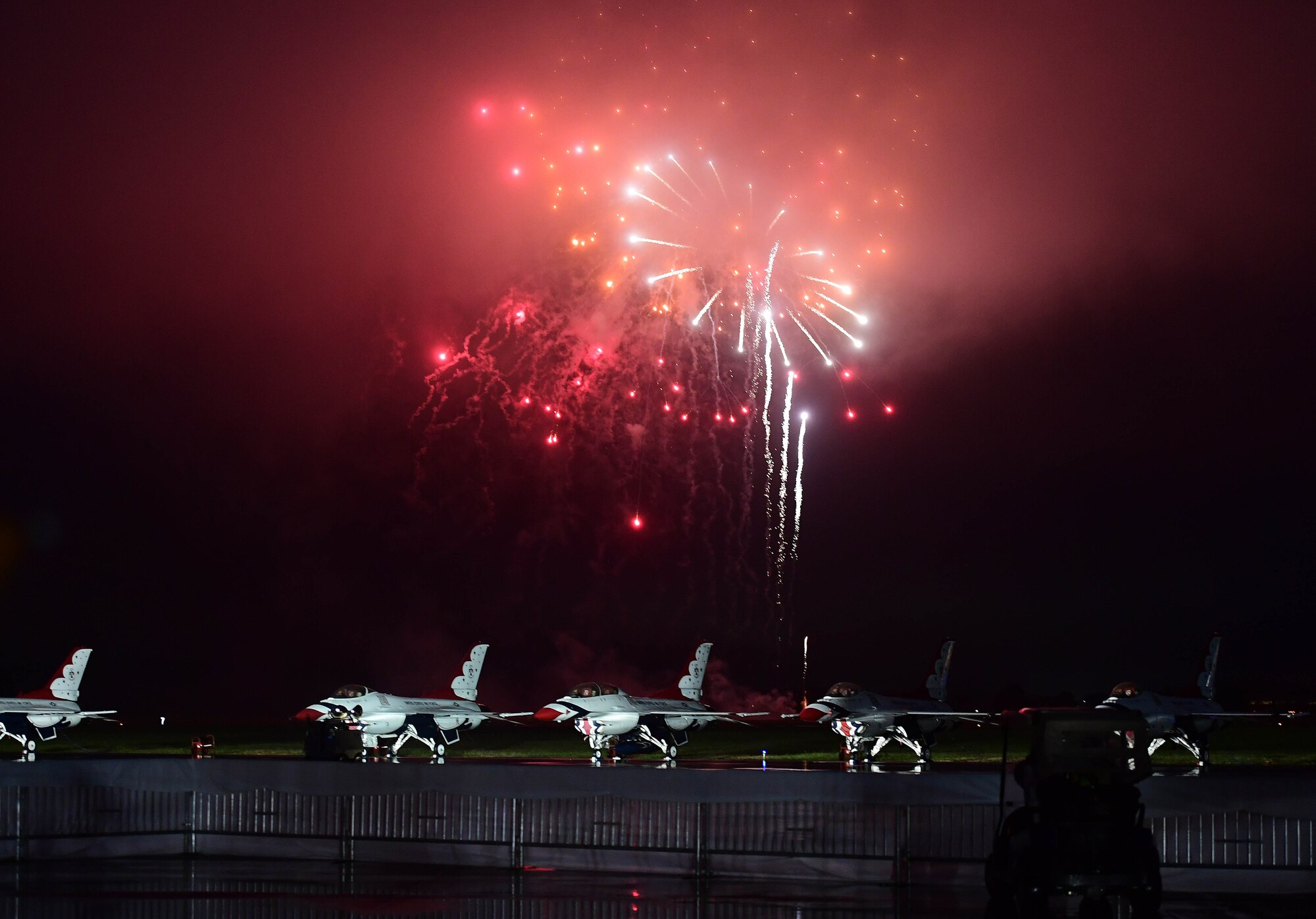 Fireworks are set off over the U.S. Air Force Thunderbirds aerial demonstration team during the Airpower Over Hampton Roads air show at Joint Base Langley-Eustis, Virginia, May 18, 2018.  This performance marked the first Thunderbirds demonstration since the start of this air show season. (U.S. Air Force photo by Senior Airman Christian Clausen)