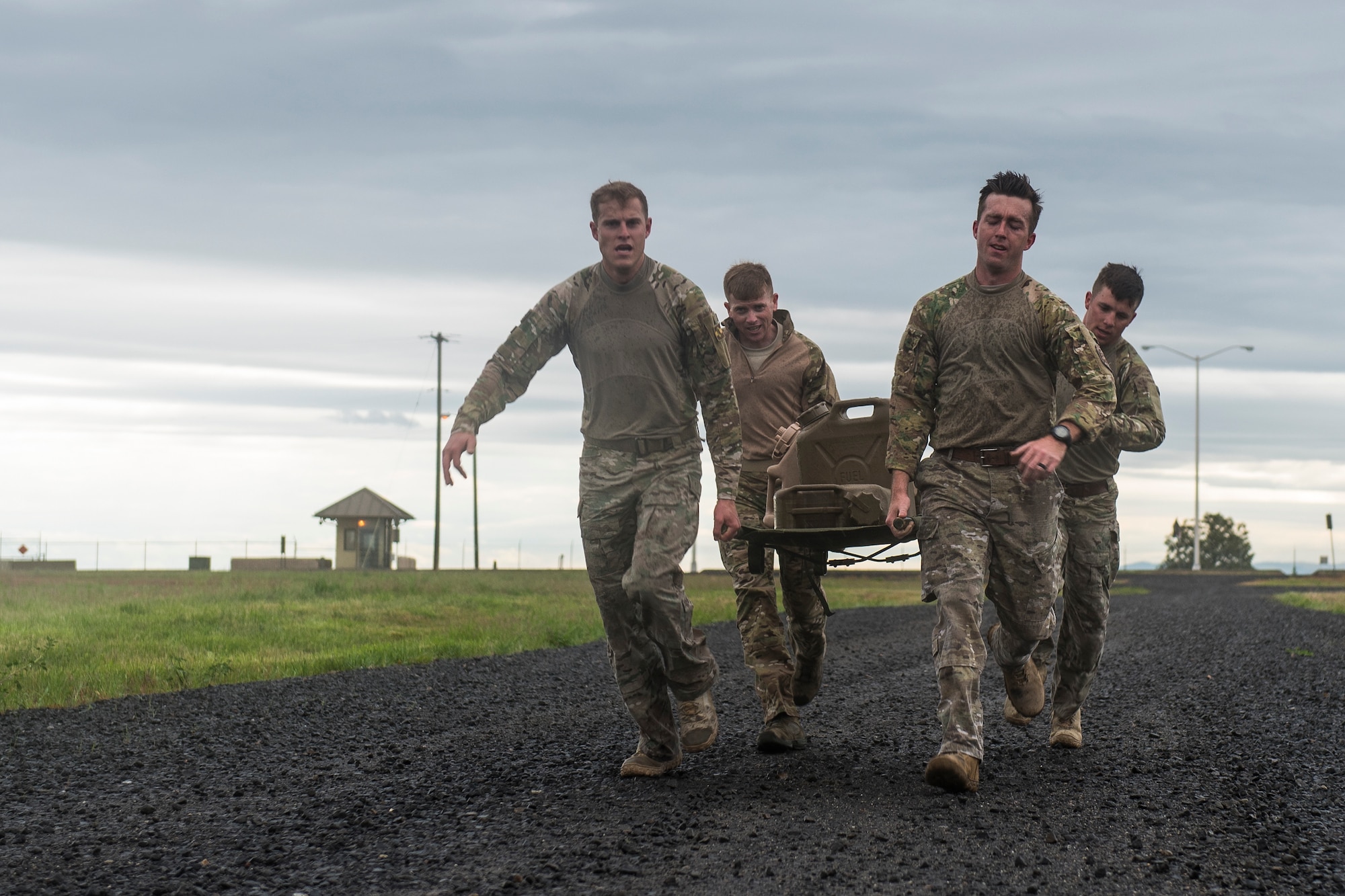 Airmen from the 22nd Training Squadron participate in the Defender Challenge during National Police Week at Fairchild Air Force Base, Washington, May 18, 2018. Teams raced to complete series of timed obstacles to include securing a building and 4-person push-ups.