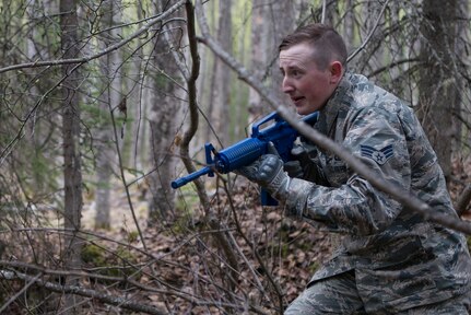 Senior Airman Talon Warren, 673d Security Forces Squadron patrolman, surveys the area after a near ambush simulation at the Defenders Day Challenge during Police Week on Joint Base Elmendorf-Richardson, Alaska, May 16, 2018. The competition was designed to test each team’s capabilities in a near ambush, improvised explosive device lane and tactical combat casualty care.