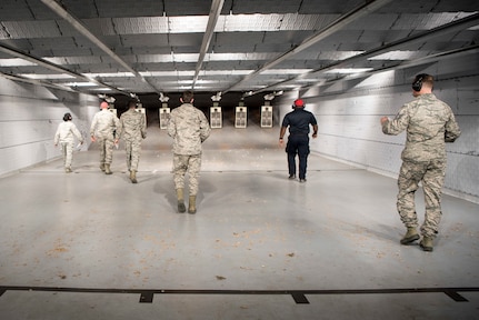 Members with the 673d Security Forces Squadron approach their targets at the Police Shooting Competition during Police Week on Joint Base Elmendorf-Richardson, Alaska, May 17, 2018. The competition was for all SFS members, Military Police and local police to showcase their marksmanship skills.