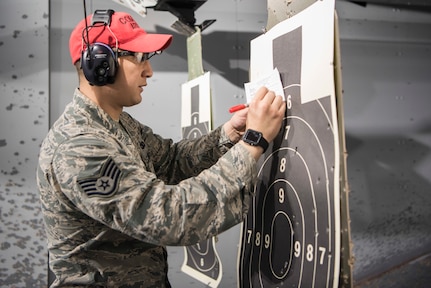 Air Force Staff Sgt. Ruben Salazar, 673d Security Forces Squadron combat arms instructor, scores a target at the Police Shooting Competition during Police Week on Joint Base Elmendorf-Richardson, Alaska, May 17, 2018. Police Week is a congressionally honored week celebrating law enforcement personnel across the nation and around the world that have made the ultimate sacrifice in the line of duty.