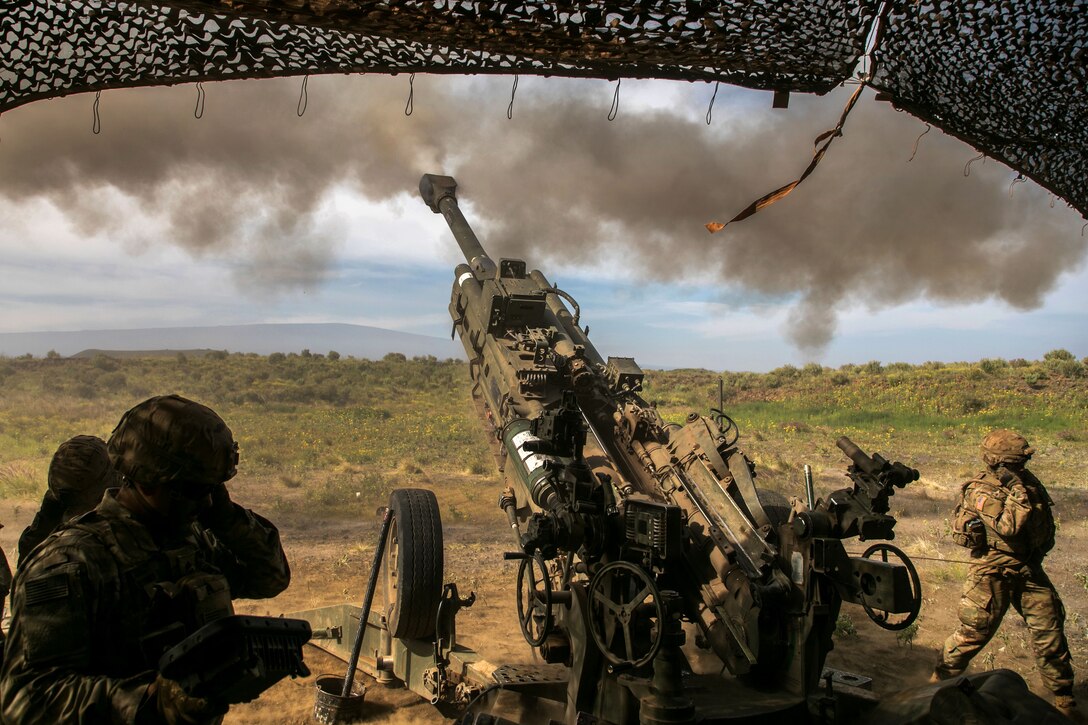 Soldiers fire an M777 howitzer during Operation Lightning Strike.