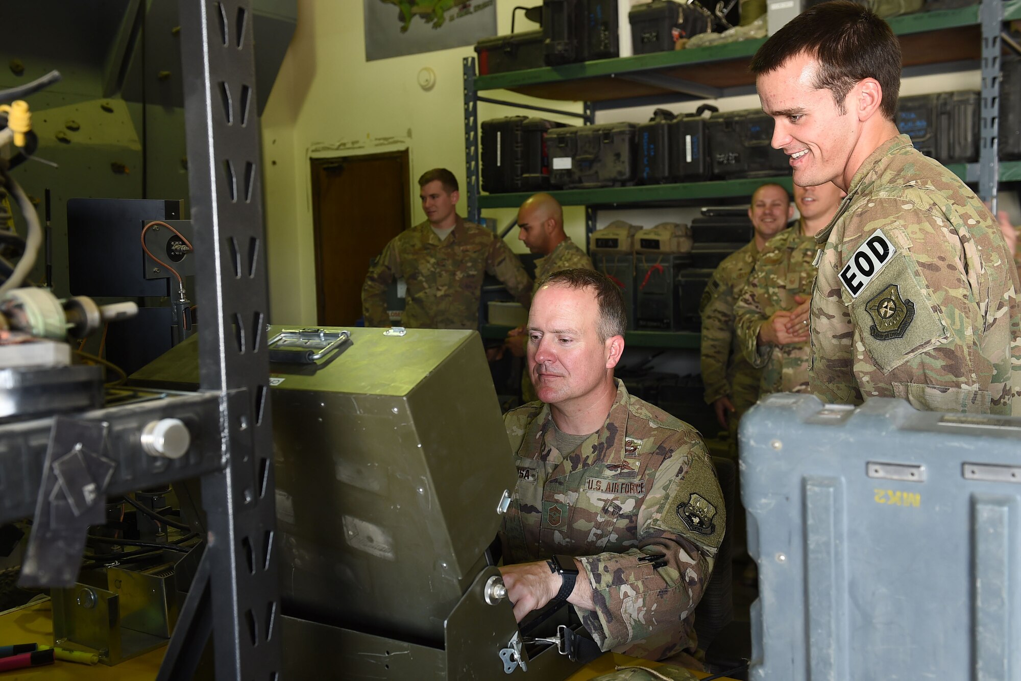 Airman shows Airman how to control robot