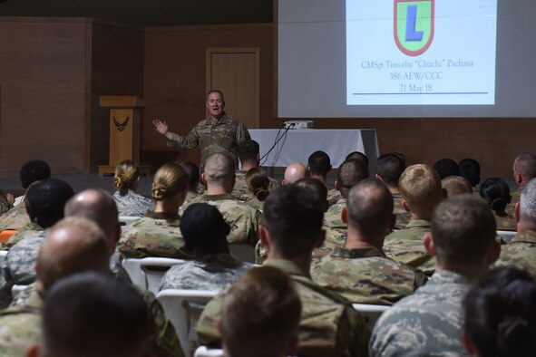 Airman briefs room filled with people