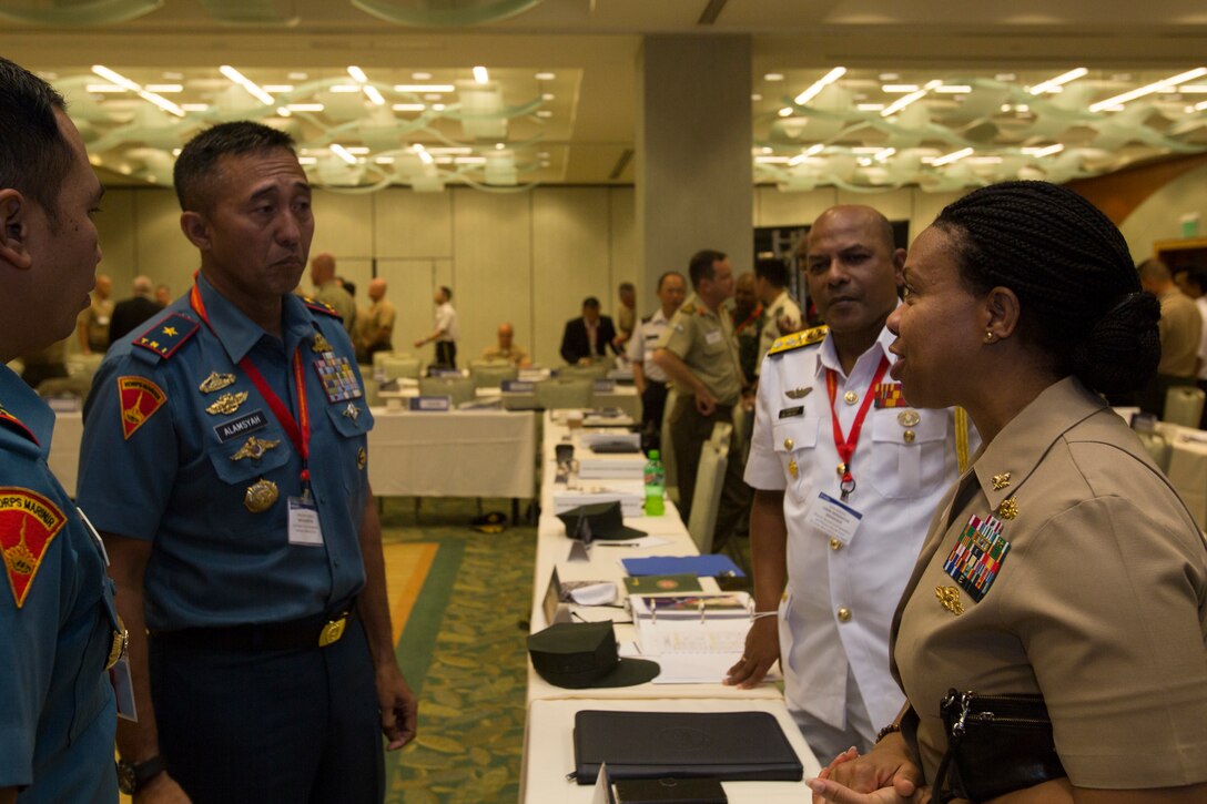 Indonesian Marine Corps Brig. Gen. Nur Alamsyah, commander, 2nd Marine Forces, speaks with U.S. Navy Cmdr. Deborah McIvy, assistant chief of staff, Fleet Ordnance and Supply, CTF-76/Expeditionary Strike Group-SEVEN, during the Pacific Amphibious Leaders Symposium 2018 in Honolulu, Hawaii, May 22, 2018. PALS brings together senior leaders of allied and partner militaries with significant interest in the security and stability of the Indo-Pacific region to discuss key aspects of maritime/amphibious operations, capability development, crisis response and interoperability. (U.S. Marine Corps photo by Cpl. Patrick Mahoney)