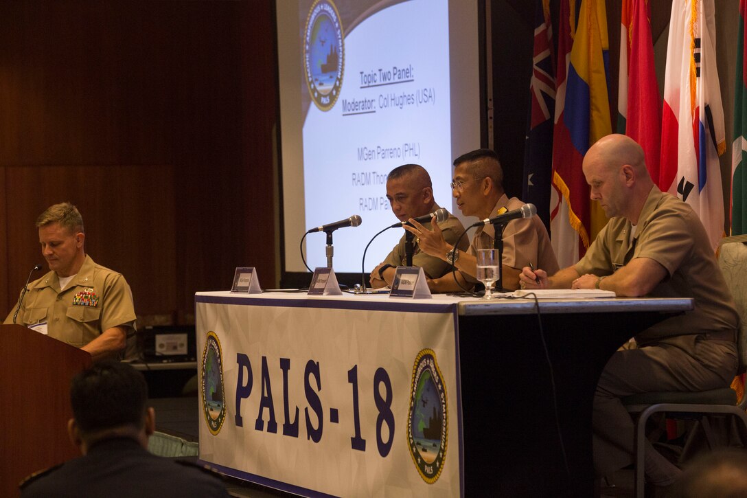 Philippine Marine Corps Maj. Gen. Alvin Parreno, left, commandant, Philippine Marine Corps; Royal Thai Navy Rear Adm. Chatchai Thongsaard, commander, Amphibious and Combat Service Support Squadron; and U.S. Navy Rear Adm. John Palmer, director, Logistics, Fleet Supply and Ordnance, U.S. Pacific Fleet, discuss logistics support to amphibious operations during the Pacific Amphibious Leaders Symposium (PALS) 2018 held in Honolulu, Hawaii, May 22, 2018.