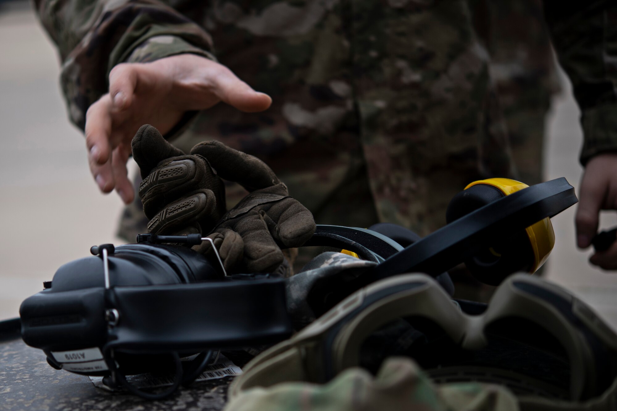 U.S Air Force Senior Airmen Dylan Rymer, 435th Contingency Response Group mobile aerial port journeyman grabs his gloves and ear-pro prior to completing a combat offload training with Royal Moroccan Armed Forces service members during Exercise African Lion 18, April 23, 2018 at Kenitra Air Base, Morocco.