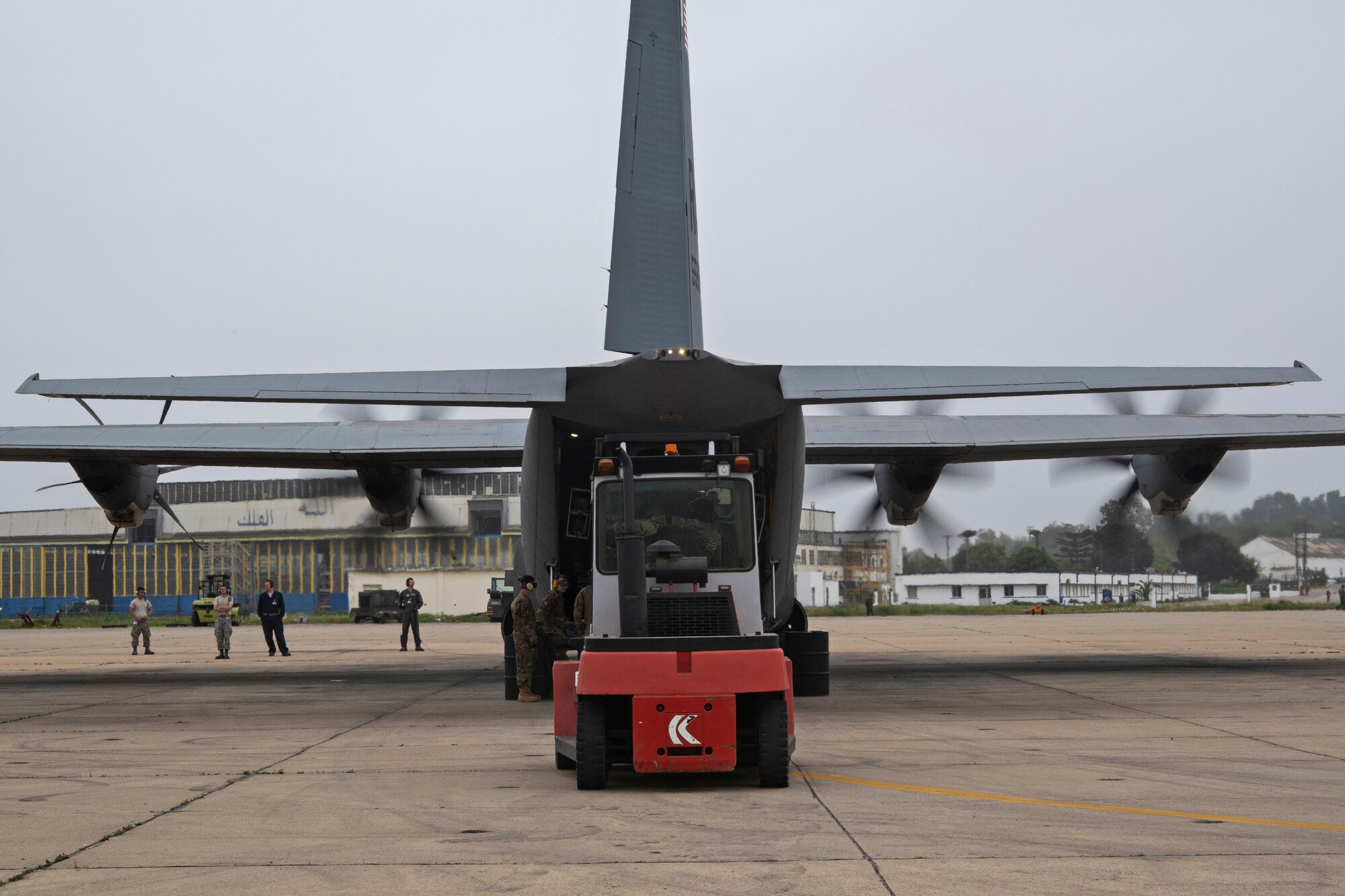 The 435th Contingency Response Group Airmen loads cargo onto a Super Hercules C130-J prior to completing a combat offload training with Royal Moroccan Armed Forces service members during Exercise African Lion 18, April 23, 2018 at Kenitra Air Base, Morocco.