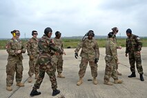 Royal Moroccan Armed Forces service members and 435th Contingency Response Group Airmen watch a Super Hercules C130-J after completing a combat offload training for Exercise African Lion 18, April 23, 2018 at Kenitra Air Base, Morocco.