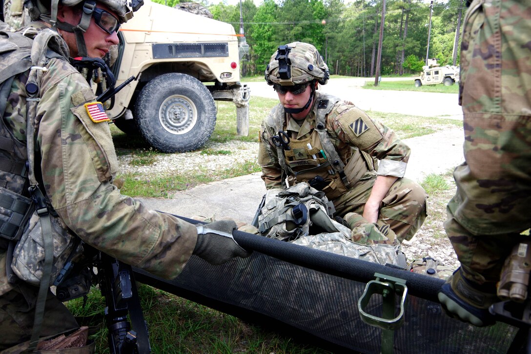 Soldiers secure a role-playing casualty.