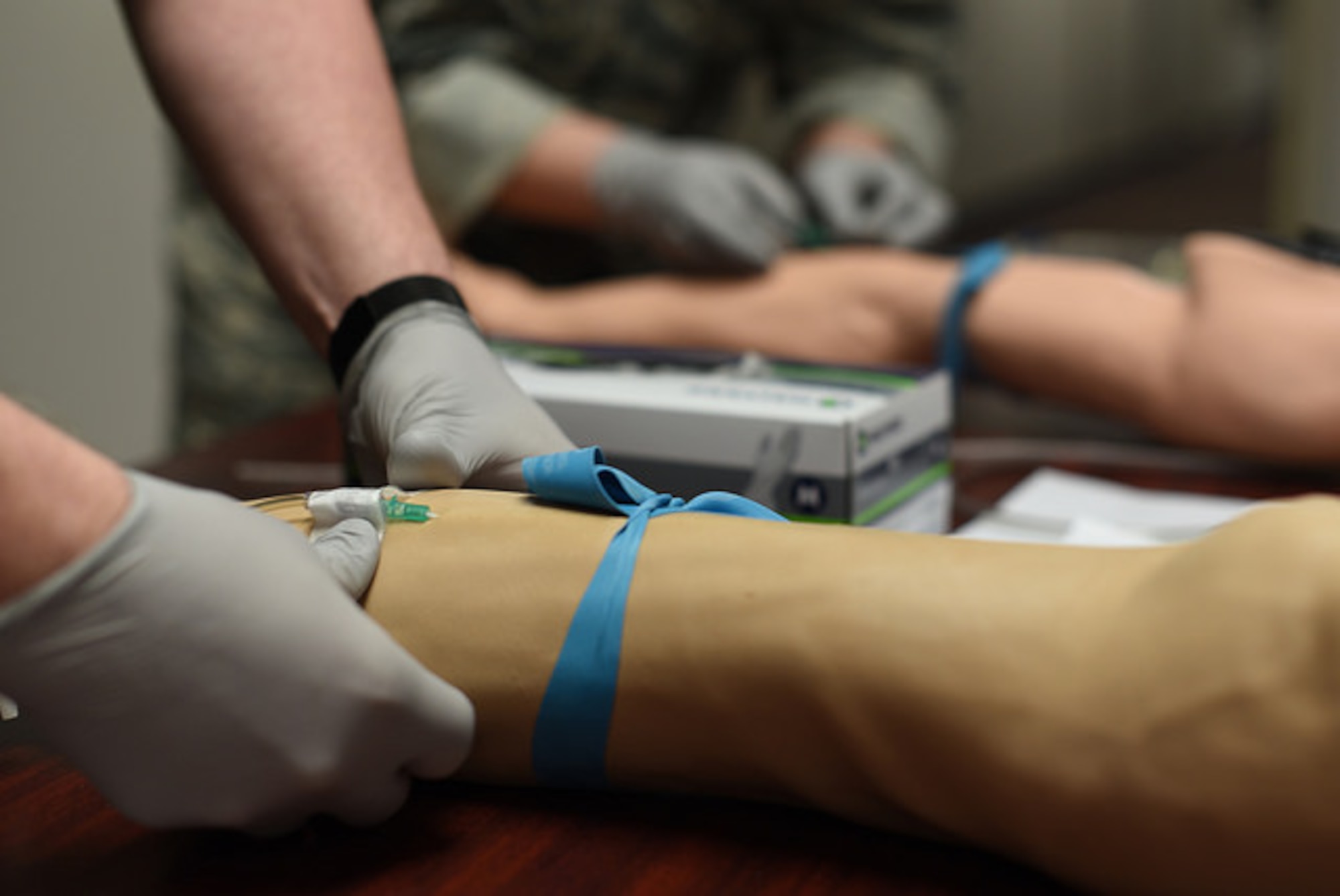 An Airman from the 87th Medical Group places an IV in a multi-venous IV training arm during an IV contest at Joint Base McGuire-Dix-Lakehurst, N.J., May 8, 2018. The IV contest was part of a series of events during nurse's week to challenge the skills of the medical staff and show appreciation for nurses. (U.S. Air Force photo by Airman Ariel Owings)
