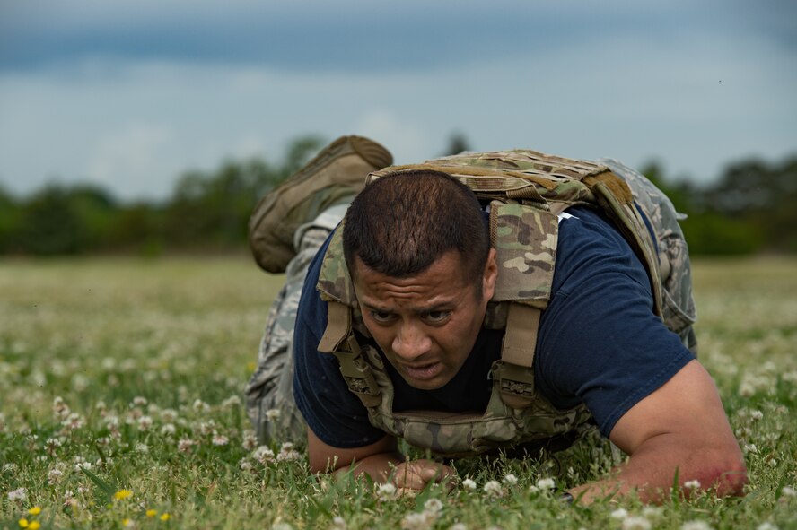 U.S. Air Force Senior Master Sgt. Dzajic Martinez, 633rd Security Forces Squadron operations superintendent, low crawls during the National Police Week Defenders’ Challenge at Joint Base Langley-Eustis, Virginia, May 16, 2018.