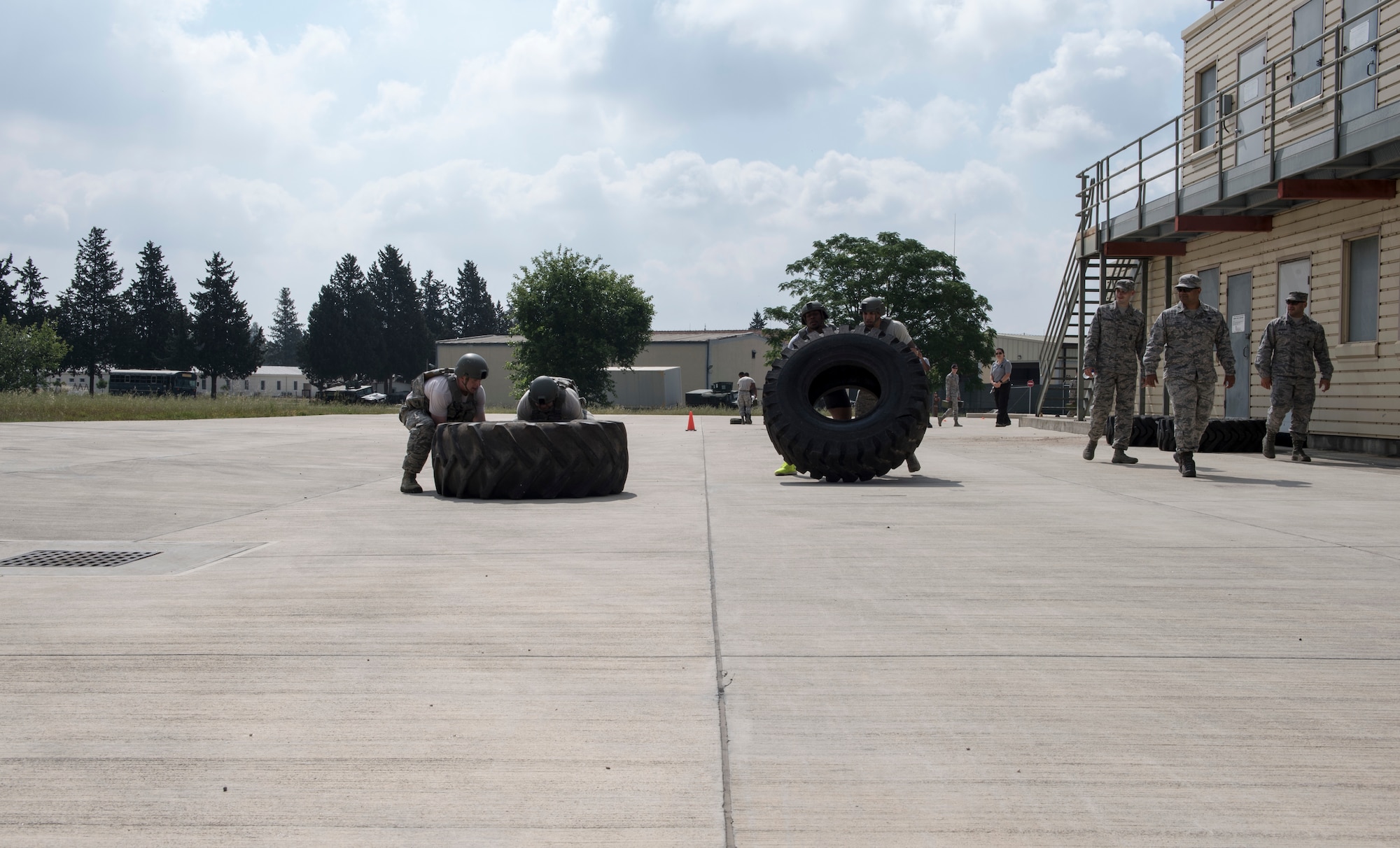 Airmen flip giant tires during event