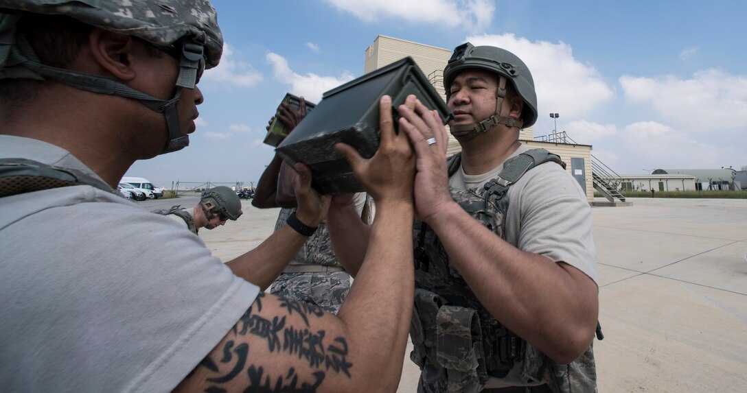 Airmen pass ammunition can back and forth during event