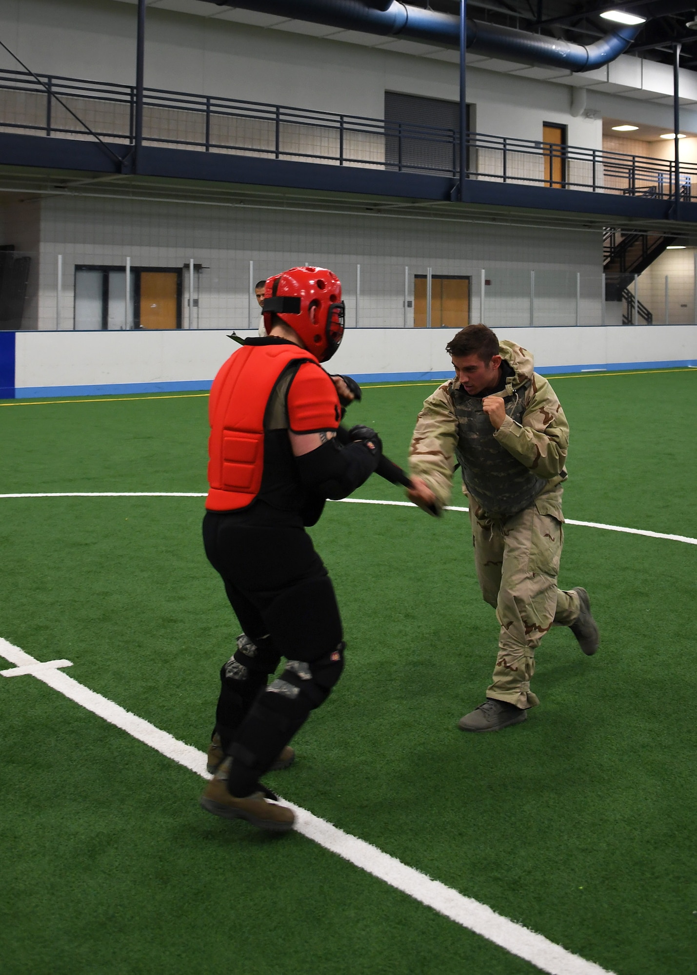 1st Lt. Gregory, RQ-4 Global Hawk pilot with the 69th Reconnaissance Group, right, applies combat techniques to Senior Airman Jeren Grantham, simulated perpetrator and instructor with the 319th Security Forces Squadron, during a readiness competition May 18, 2018, at Grand Forks Air Force Base, North Dakota. Hand-to-hand combat was one of the many stations at the competition meant to test teams from units across the base on their knowledge and application of readiness skills. (U.S. Air Force photo by Airman 1st Class Elora J. Martinez)