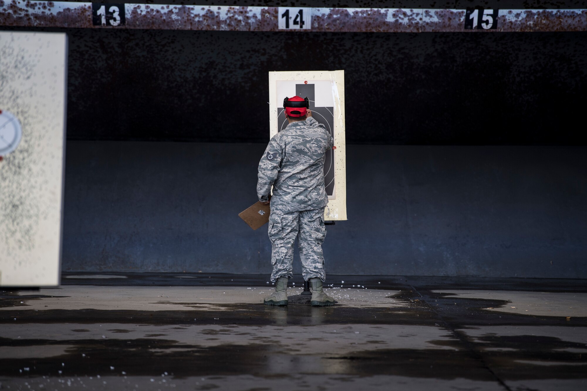 Airman checks practice shooting tool during competition