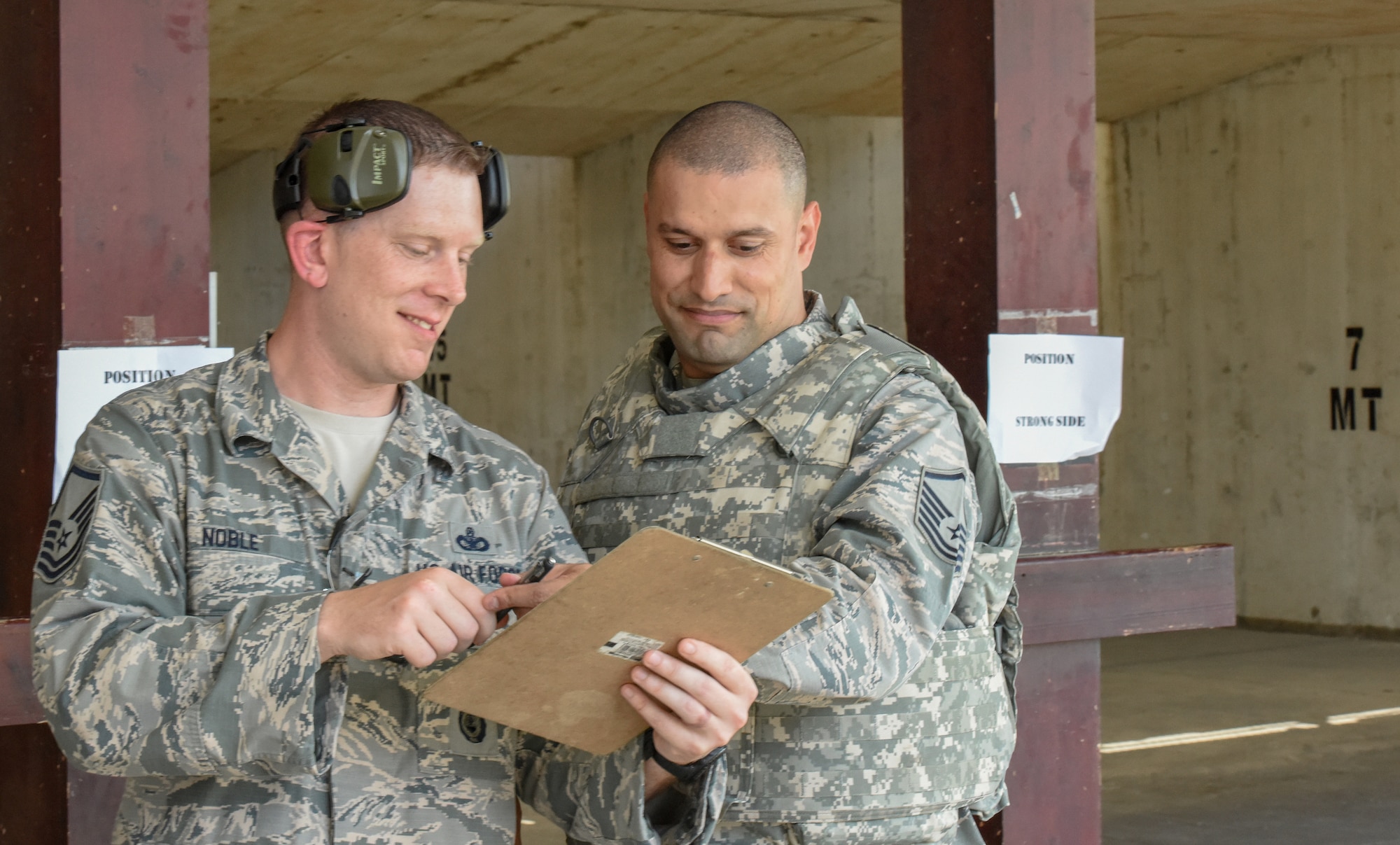 Security forces member shows M9 pistol firing competition contestent his scoring sheet.
