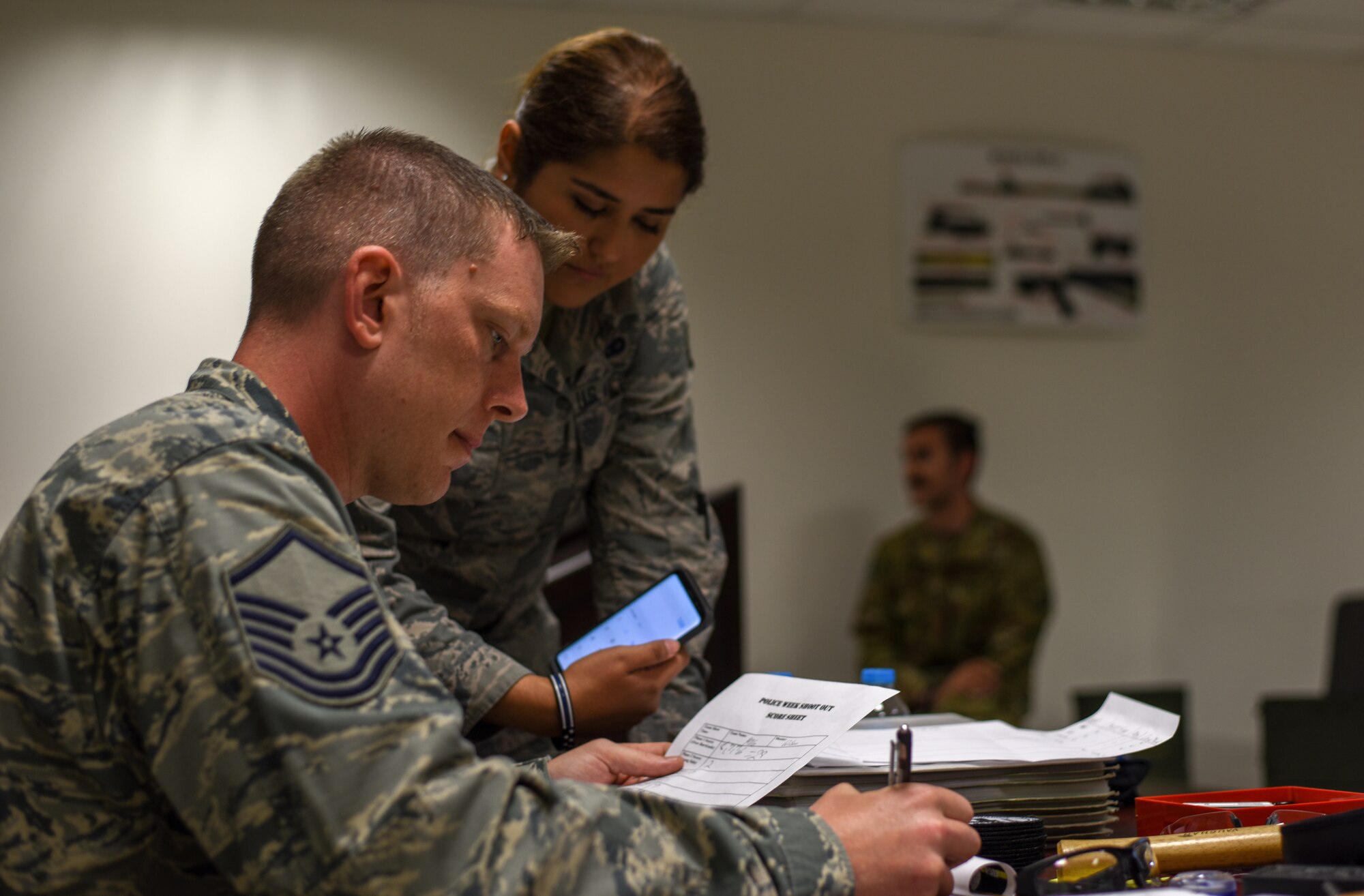 Airmen calculate the scores of the firing competition.