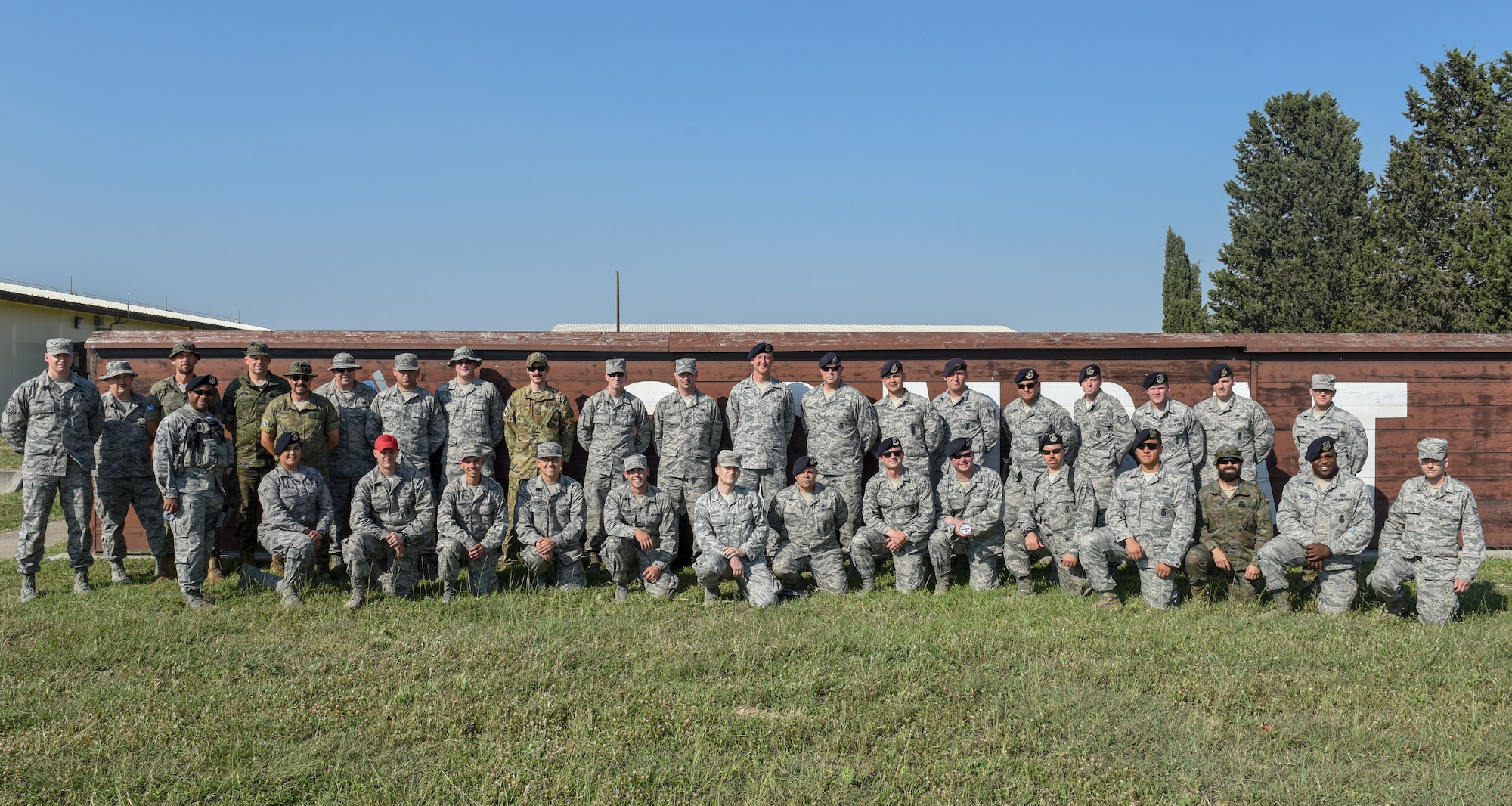 Group poses for photo after the M9 pistol firing competition.