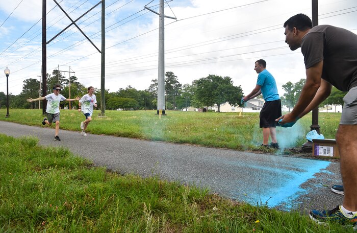 Kids from the Joint Base Charleston Youth Center prepare to be hit with colored chalk during a color run May 18, 2018, at JB Charleston, S.C.