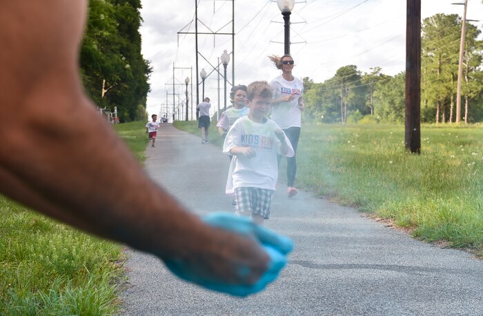 Kids from the Joint Base Charleston Youth Center prepare to be hit with colored chalk during a color run May 18, 2018, at JB Charleston, S.C.